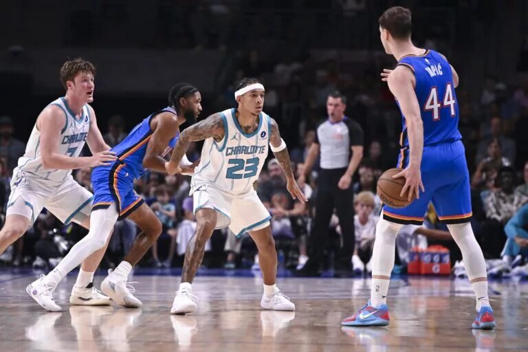 Charlotte Hornets guard Tre Mann (23) defends against Oklahoma City Thunder Nikola Topic (44)