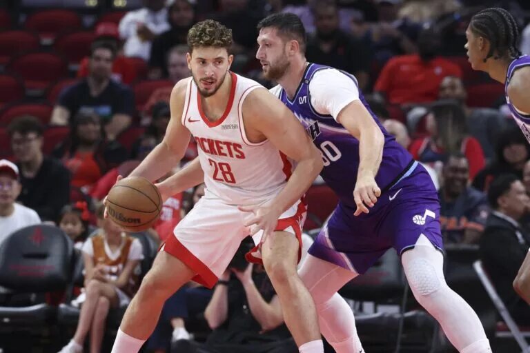 Oct 8, 2025; Houston, Texas, USA; Houston Rockets center Alperen Sengun (28) controls the ball as Utah Jazz center Jusuf Nurkic (30) defends during the second quarter at Toyota Center. Mandatory Credit: Troy Taormina-Imagn Images