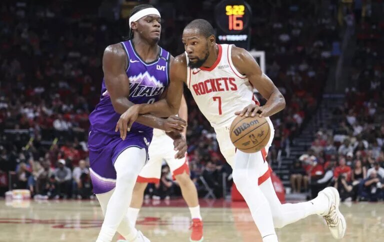 Oct 8, 2025; Houston, Texas, USA; Houston Rockets forward Kevin Durant (7) dribbles the ball as Utah Jazz forward Taylor Hendricks (0) defends during the third quarter at Toyota Center. Mandatory Credit: Troy Taormina-Imagn Images