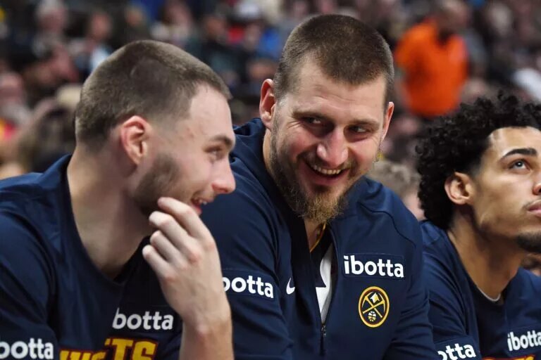 Denver Nuggets center Nikola Jokic laughs with teammate Christian Braun