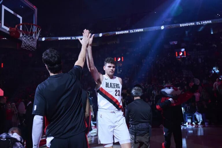 Oct 14, 2025; Portland, Oregon, USA; Portland Trail Blazers center Donovan Clingan (23) high fives forward Deni Avdija (8) before a game against the Golden State Warriors at Moda Center. Mandatory Credit: Troy Wayrynen-Imagn Images