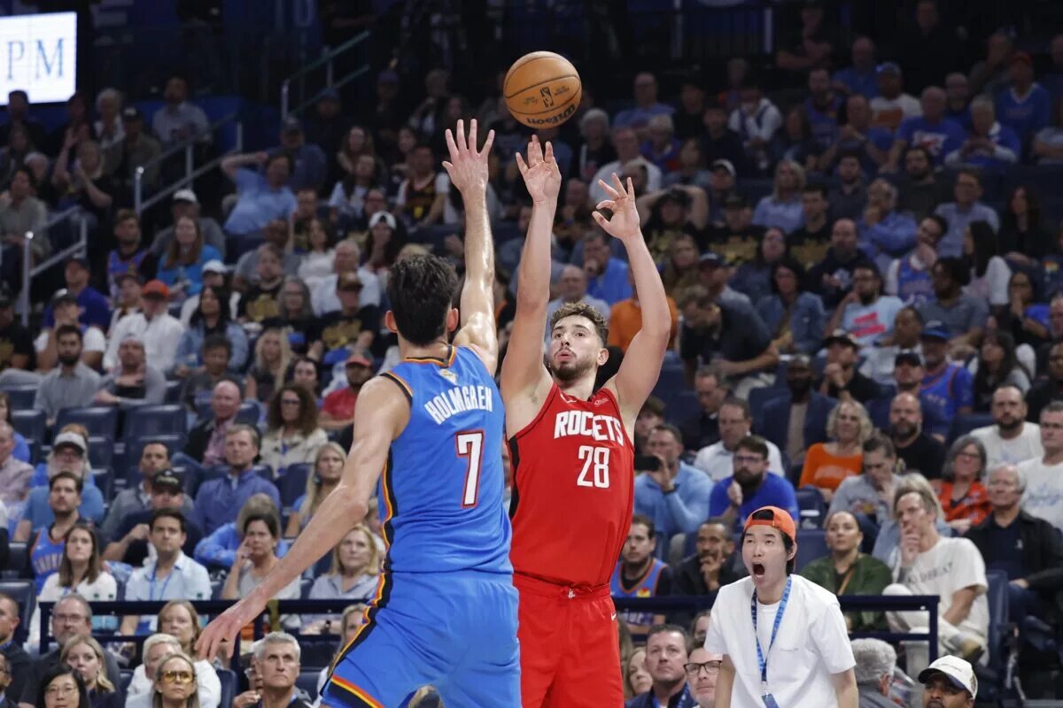Oct 21, 2025; Oklahoma City, Oklahoma, USA; Houston Rockets center Alperen Sengun (28) shoots over Oklahoma City Thunder center Chet Holmgren (7) during the second half at Paycom Center. Mandatory Credit: Alonzo Adams-Imagn Images
