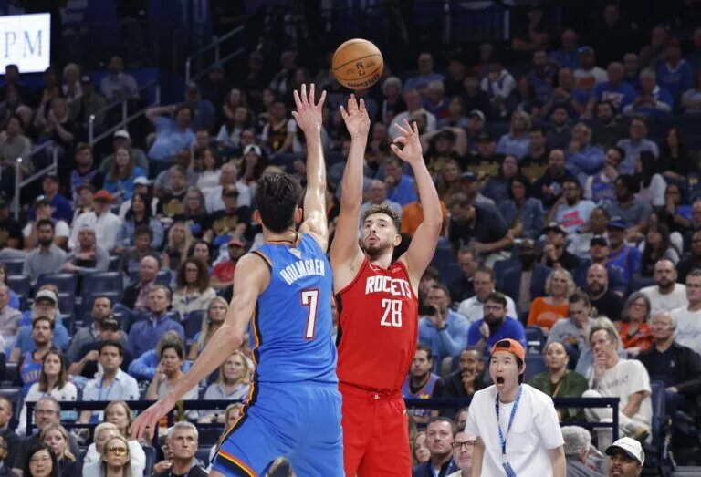 Oct 21, 2025; Oklahoma City, Oklahoma, USA; Houston Rockets center Alperen Sengun (28) shoots over Oklahoma City Thunder center Chet Holmgren (7) during the second half at Paycom Center. Mandatory Credit: Alonzo Adams-Imagn Images