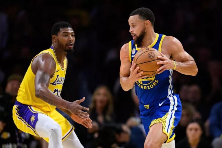 Oct 21, 2025; Los Angeles, California, USA; Golden State Warriors guard Stephen Curry (30) drives past Los Angeles Lakers guard Marcus Smart (36) during the first half at Crypto.com Arena. Mandatory Credit: William Liang-Imagn Images