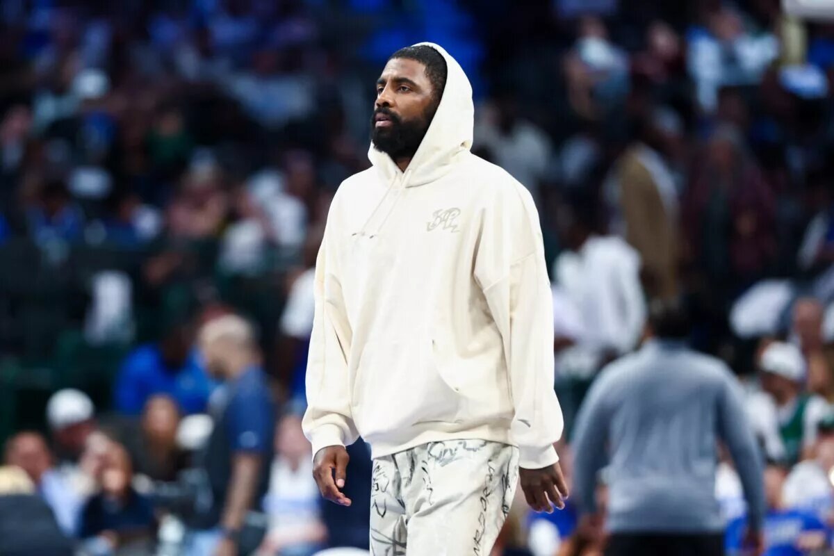 Oct 22, 2025; Dallas, Texas, USA; Dallas Mavericks injured guard Kyrie Irving walks across the court during the game against the San Antonio Spurs at American Airlines Center. Mandatory Credit: Kevin Jairaj-Imagn Images