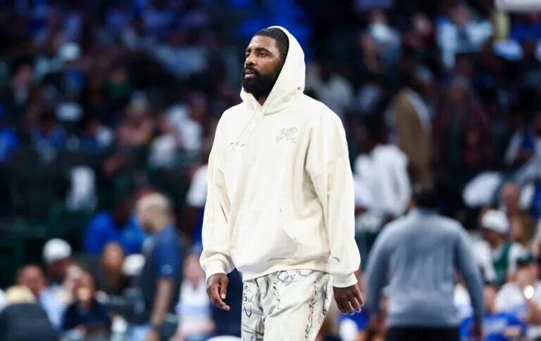 Oct 22, 2025; Dallas, Texas, USA; Dallas Mavericks injured guard Kyrie Irving walks across the court during the game against the San Antonio Spurs at American Airlines Center. Mandatory Credit: Kevin Jairaj-Imagn Images