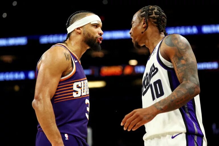 Oct 22, 2025; Phoenix, Arizona, USA; Phoenix Suns forward Dillon Brooks (3) and Sacramento Kings guard DeMar DeRozan (10) exchange words during the second half at the Mortgage Matchup Center. Mandatory Credit: Mark J. Rebilas-Imagn Images