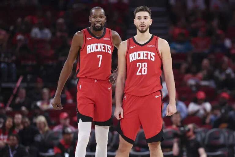 Oct 24, 2025; Houston, Texas, USA; Houston Rockets forward Kevin Durant (7) and center Alperen Sengun (28) stand on the court during the first quarter against the Detroit Pistons at Toyota Center. Mandatory Credit: Troy Taormina-Imagn Images