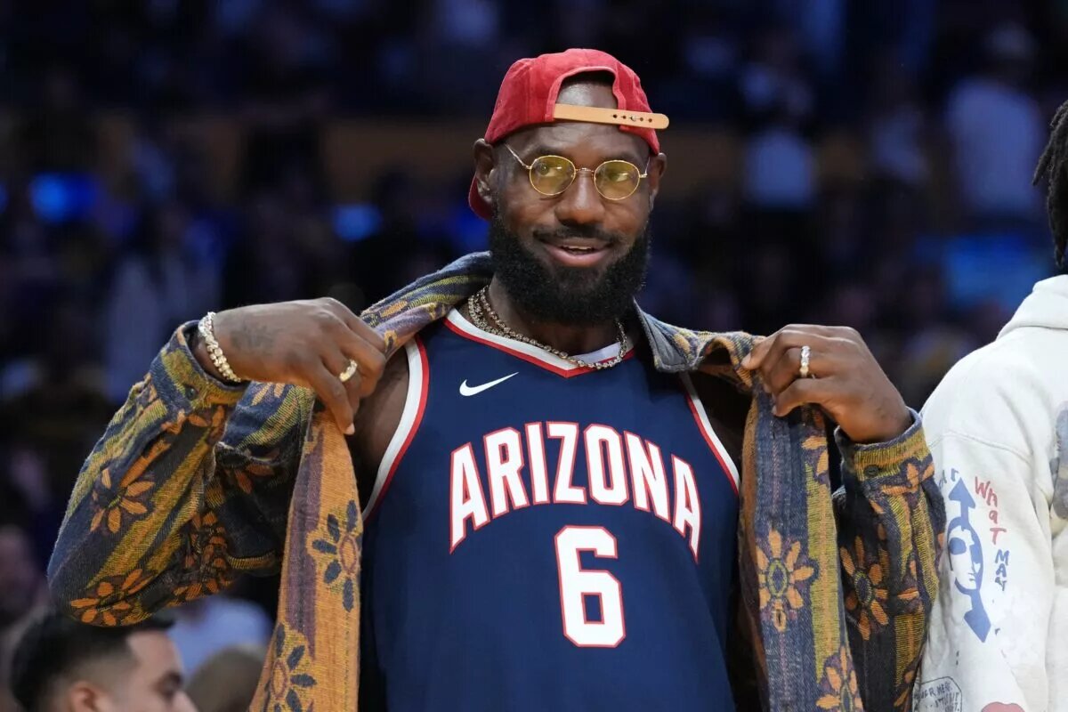 Oct 24, 2025; Los Angeles, California, USA; Los Angeles Lakers forward LeBron James poses in the Arizona Wildcats jersey of his son Bryce James (6) during the game against the Minnesota Timberwolves at Crypto.com Arena. Mandatory Credit: Kirby Lee-Imagn Images