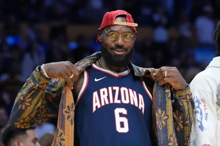 Oct 24, 2025; Los Angeles, California, USA; Los Angeles Lakers forward LeBron James poses in the Arizona Wildcats jersey of his son Bryce James (6) during the game against the Minnesota Timberwolves at Crypto.com Arena. Mandatory Credit: Kirby Lee-Imagn Images