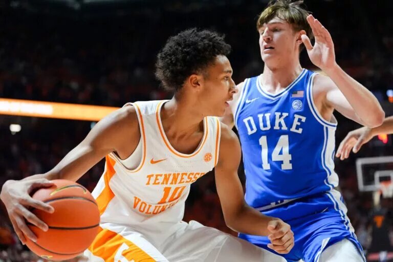 Tennessee forward Nate Ament (10) moves the ball while guarded by Duke guard/forward Nikolas Khamenia (14) during a college basketball exhibition game on October 26, 2025, in Knoxville, Tenn.