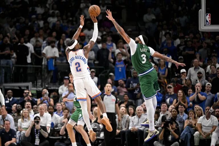 Oct 27, 2025; Dallas, Texas, USA; Oklahoma City Thunder guard Shai Gilgeous-Alexander (2) makes a jump shot over Dallas Mavericks forward Anthony Davis (3) during the second half at the American Airlines Center. Mandatory Credit: Jerome Miron-Imagn Images