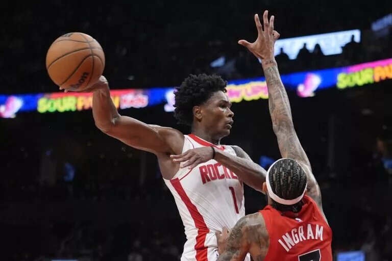 Oct 29, 2025; Toronto, Ontario, CAN; Houston Rockets forward Amen Thompson (1) does a no-look pass against Toronto Raptors forward Brandon Ingram (3) during the second half at Scotiabank Arena. Mandatory Credit: John E. Sokolowski-Imagn Images