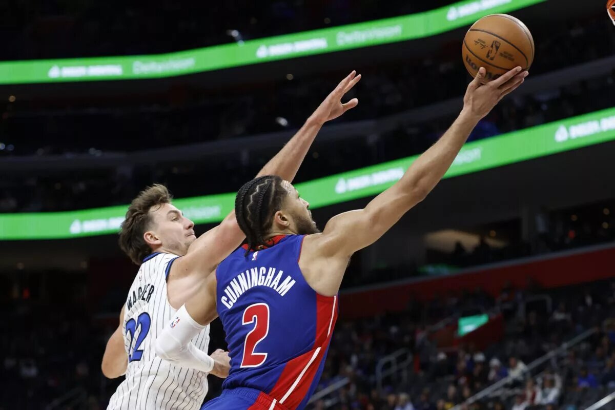 Oct 29, 2025; Detroit, Michigan, USA; Detroit Pistons guard Cade Cunningham (2) shoots on Orlando Magic forward Franz Wagner (22) in the second half at Little Caesars Arena. Mandatory Credit: Rick Osentoski-Imagn Images