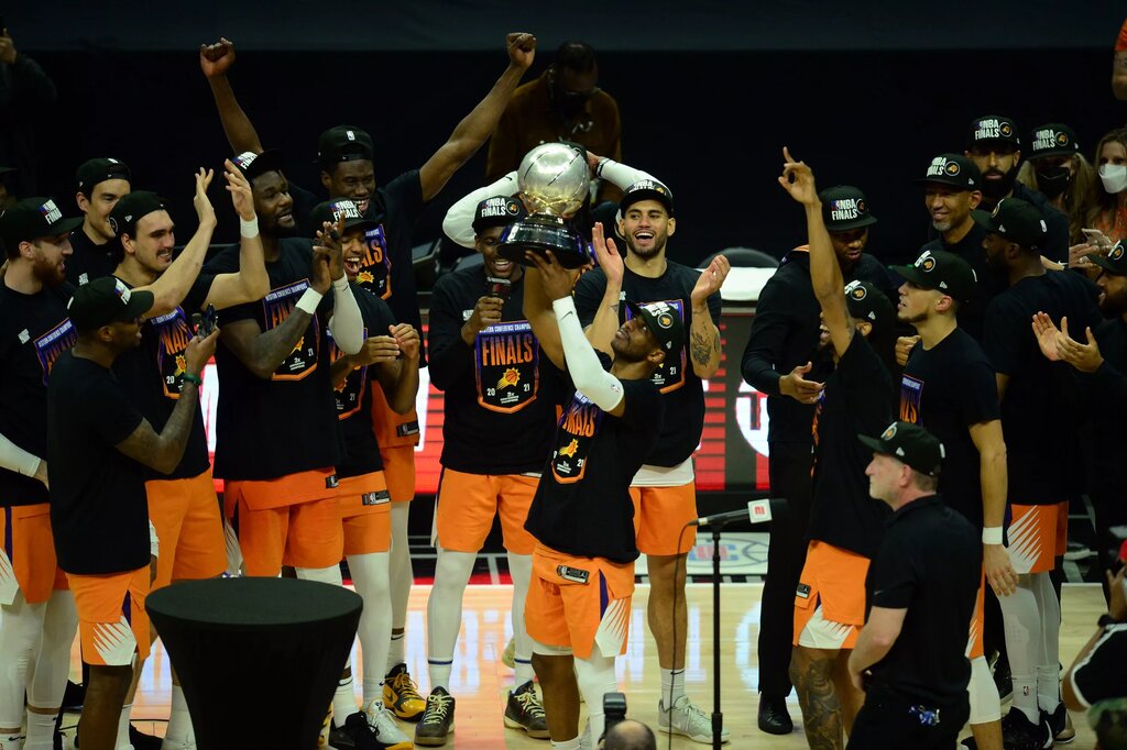Jun 30, 2021; Los Angeles, California, USA; Phoenix Suns guard Chris Paul (3) lifts the Western Conference champions trophy following the series victory against the Los Angeles Clippers in game six of the Western Conference Finals for the 2021 NBA Playoffs at Staples Center. Mandatory Credit: Gary A. Vasquez-USA TODAY Sports