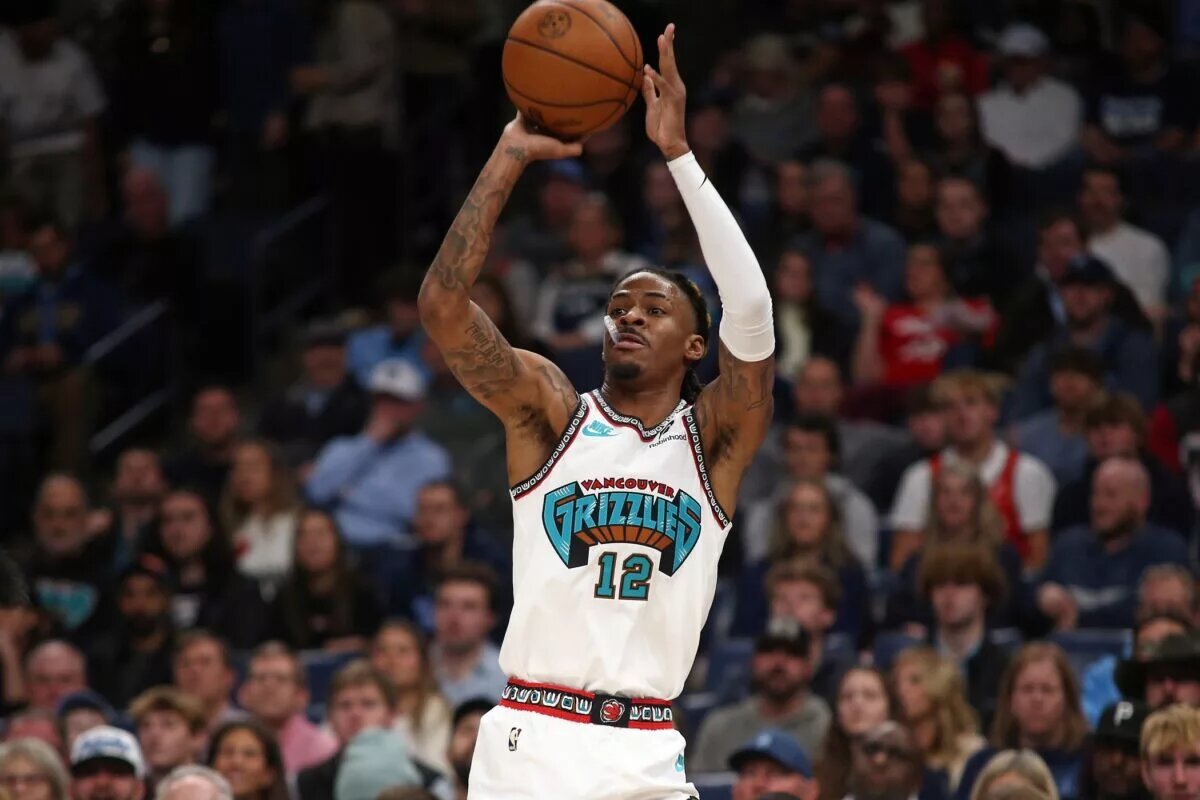 Dec 23, 2024; Memphis, Tennessee, USA; Memphis Grizzlies guard Ja Morant (12) shoots for three during the first quarter against the Los Angeles Clippers at FedExForum. Mandatory Credit: Petre Thomas-Imagn Images