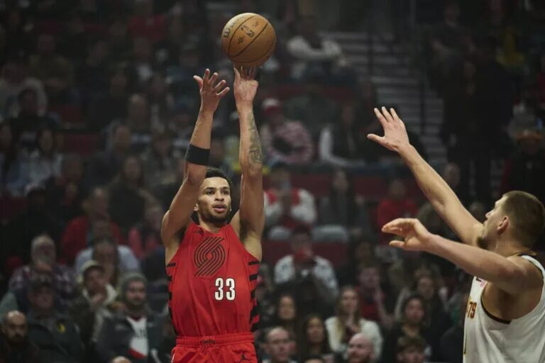 Oct 31, 2025; Portland, Oregon, USA; Portland Trail Blazers forward Toumani Camara (33) shoots a jump shot during the first half against Denver Nuggets center Nikola Jokic (15) at Moda Center. Mandatory Credit: Troy Wayrynen-Imagn Images