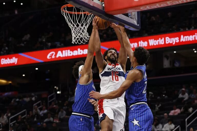 Nov 1, 2025; Washington, District of Columbia, USA; Washington Wizards forward Anthony Gill (16) attempts a shot as Orlando Magic forward Noah Penda (93) and Magic forward Tristan da Silva (23) defend in the second half at Capital One Arena. Mandatory Credit: Geoff Burke-Imagn Images