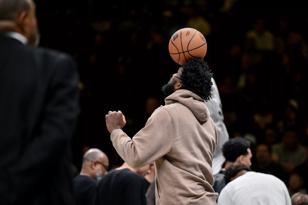 Philadelphia 76ers center Joel Embiid (21) balances a basketball on his head as his team has a timeout during the second half against the Brooklyn Nets at Barclays Center. 