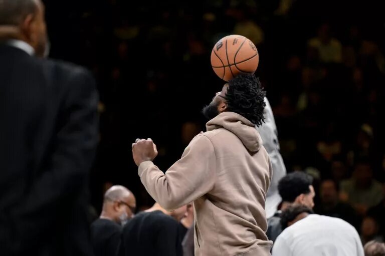Philadelphia 76ers center Joel Embiid (21) balances a basketball on his head as his team has a timeout during the second half against the Brooklyn Nets at Barclays Center.