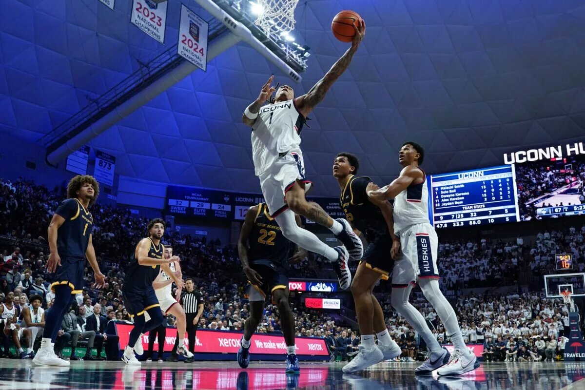 Nov 3, 2025; Storrs, Connecticut, USA; UConn Huskies guard Solo Ball (1) drives to the basket against tech New Haven Chargers in the second half at Harry A. Gampel Pavilion. Mandatory Credit: David Butler II-Imagn Images