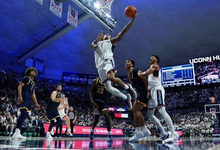Nov 3, 2025; Storrs, Connecticut, USA; UConn Huskies guard Solo Ball (1) drives to the basket against tech New Haven Chargers in the second half at Harry A. Gampel Pavilion. Mandatory Credit: David Butler II-Imagn Images
