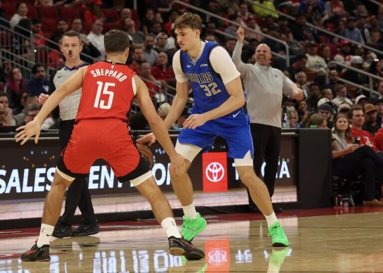 Dallas Mavericks forward Cooper Flagg (32) dribbles against Houston Rockets guard Reed Sheppard (15) in the third quarter at Toyota Center.