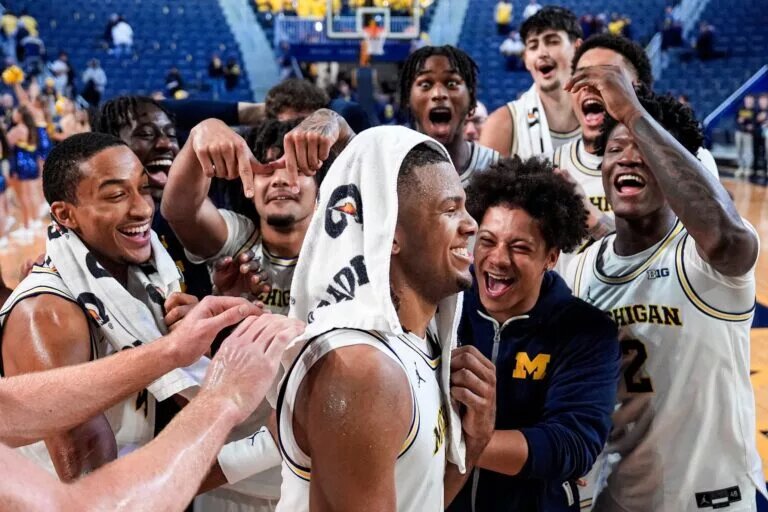 Michigan players celebrate around guard Trey McKenney (1) after 121-78 win over Oakland at Crisler Center in Ann Arbor on Monday, November 3, 2025.