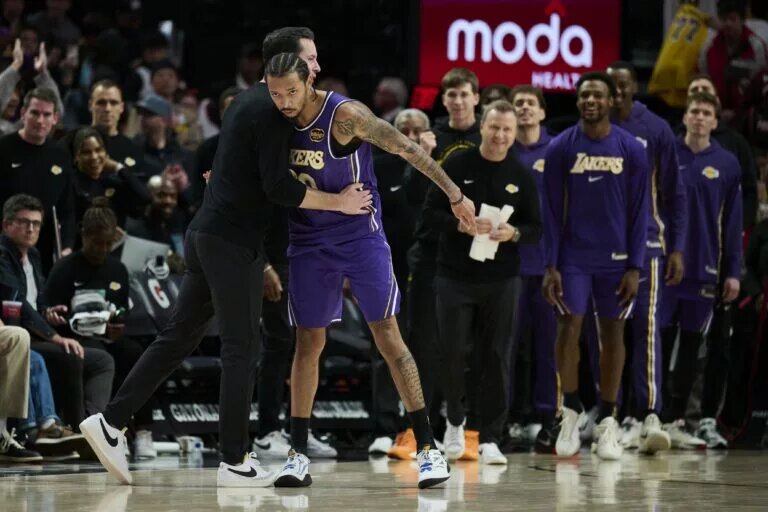 Nov 3, 2025; Portland, Oregon, USA; Los Angeles Lakers guard Nick Smith Jr. (20) celebrates with head coach JJ Redick after a game against the Portland Trail Blazers at Moda Center. Mandatory Credit: Troy Wayrynen-Imagn Images