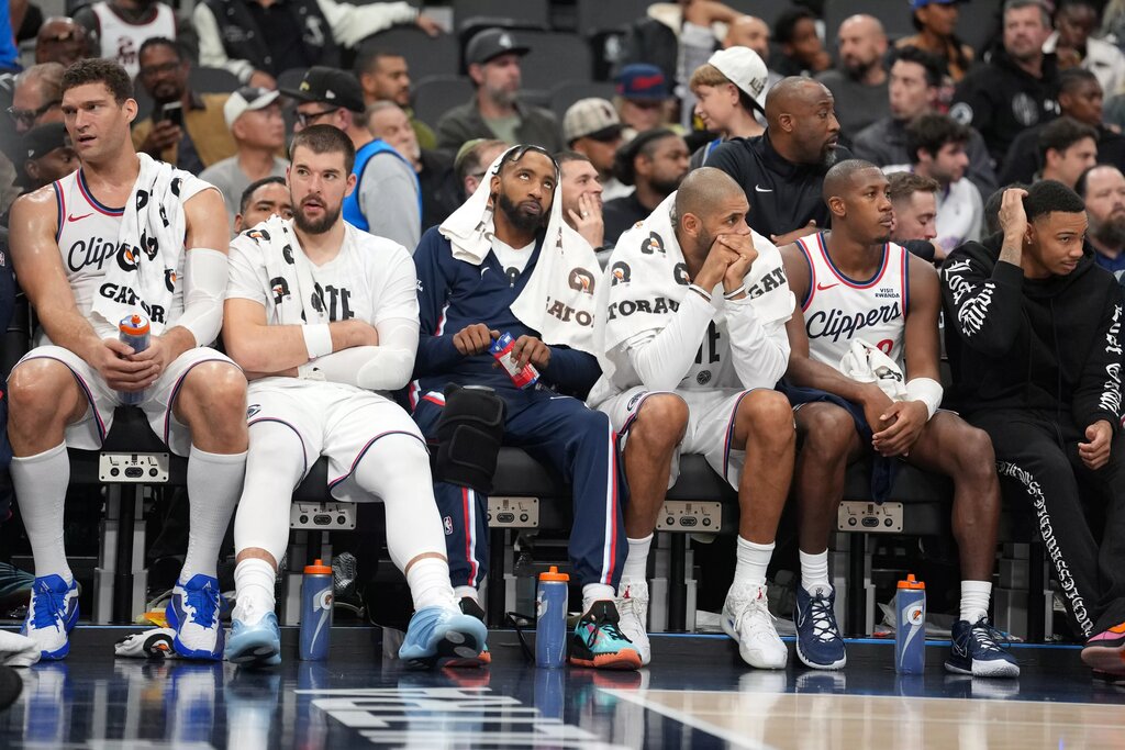 LA Clippers players (from left) center Brook Lopez (11), center Ivica Zubac (40), forward Derrick Jones Jr. (5), forward Nicolas Batum (33) and guard Kris Dunn (8) watch on the bench against the Oklahoma City Thunder in the second half at Intuit Dome.