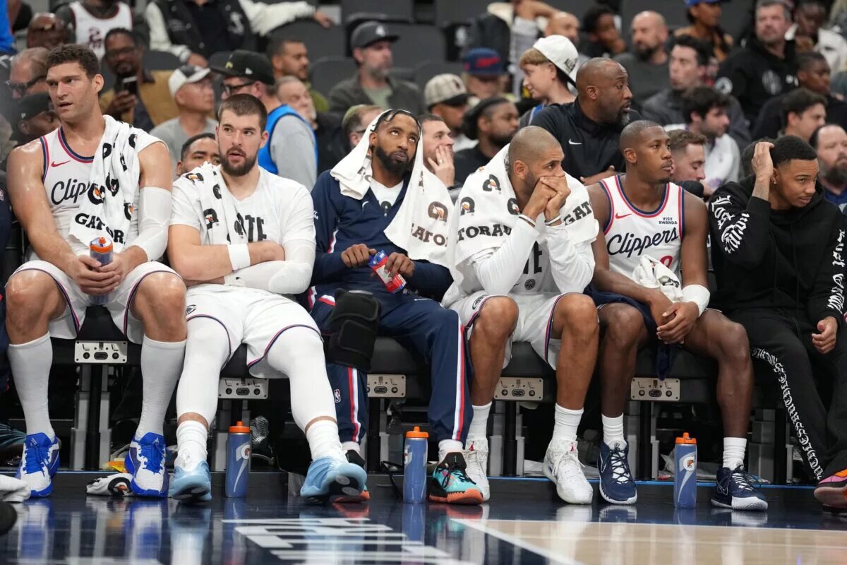 LA Clippers players (from left) center Brook Lopez (11), center Ivica Zubac (40), forward Derrick Jones Jr. (5), forward Nicolas Batum (33) and guard Kris Dunn (8) watch on the bench against the Oklahoma City Thunder in the second half at Intuit Dome.