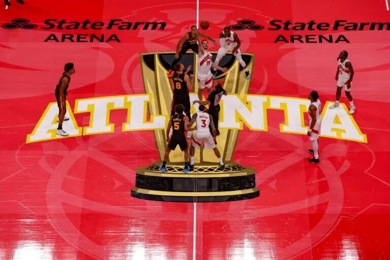 Toronto Raptors center Jakob Poeltl (19) takes the opening tip from Atlanta Hawks center Kristaps Porzingis (8) in the first quarter at State Farm Arena.