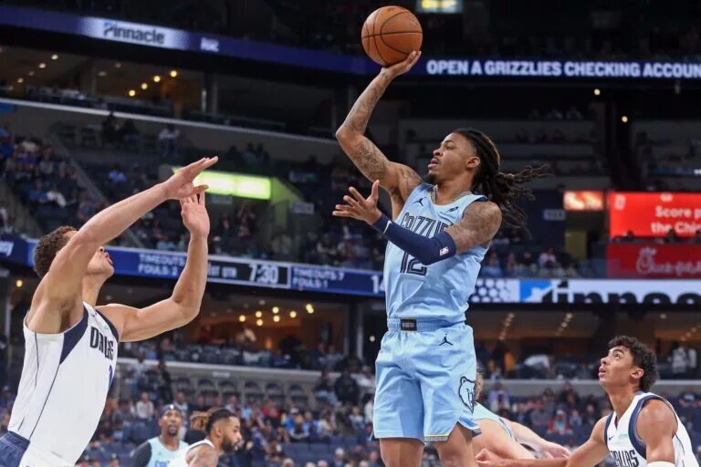 Nov 7, 2025; Memphis, Tennessee, USA; Memphis Grizzlies guard Ja Morant (12) shoots during the first quarter against the Dallas Mavericks at FedExForum. Mandatory Credit: Petre Thomas-Imagn Images