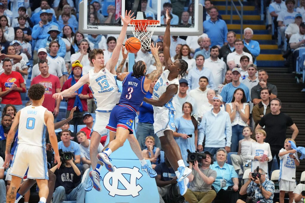  Kansas Jayhawks guard Tre White (3) shoots as North Carolina Tar Heels center Henri Veesaar (13) and forward Caleb Wilson (8) defend in the second half at Dean E. Smith Center.