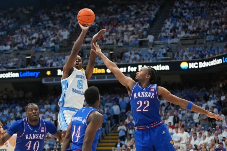 North Carolina Tar Heels forward Caleb Wilson (8) shoots as Kansas Jayhawks forward Flory Bidunga (40) and guard Melvin Council Jr. (14) and guard Darryn Peterson (22) defend in the second half at Dean E. Smith Center.
