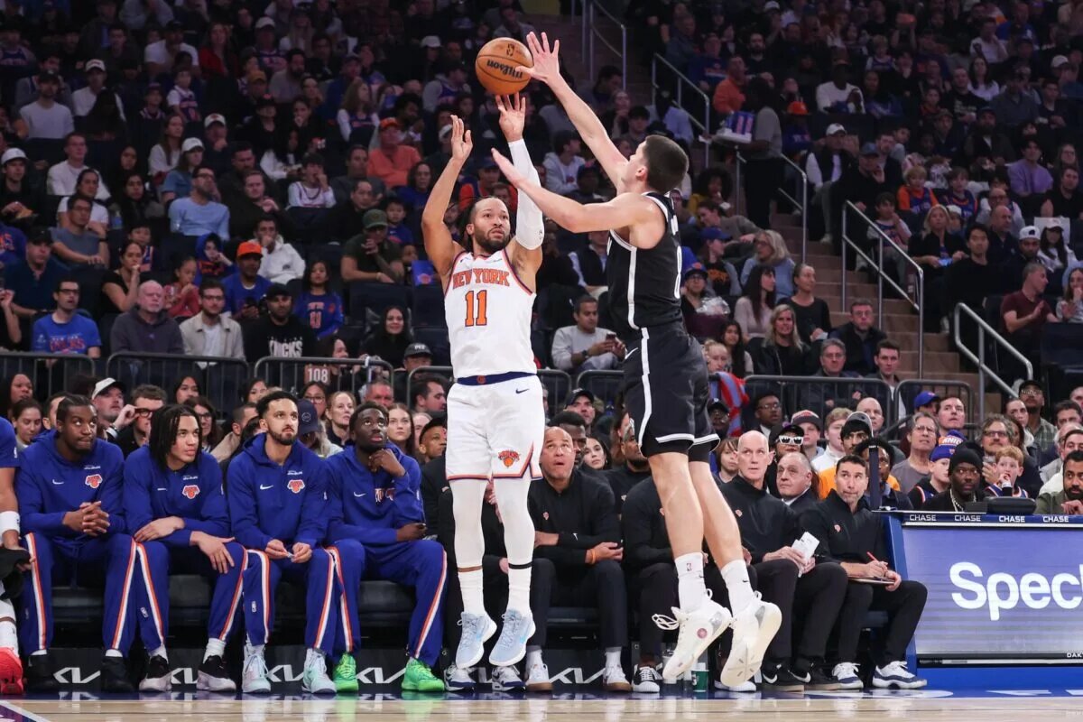 Nov 9, 2025; New York, New York, USA; New York Knicks guard Jalen Brunson (11) takes a three point shot past Brooklyn Nets guard Egor Demin (8) in the first quarter at Madison Square Garden. Mandatory Credit: Wendell Cruz-Imagn Images