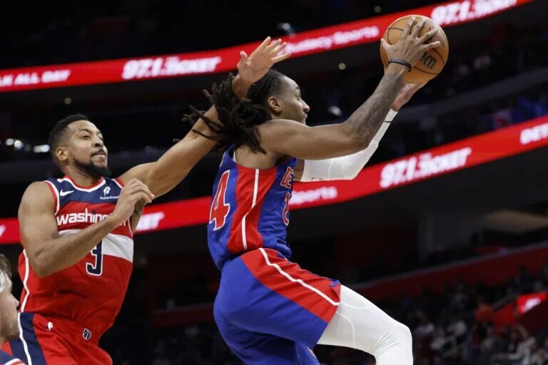 Nov 10, 2025; Detroit, Michigan, USA; Detroit Pistons guard Daniss Jenkins (24) shoots on Washington Wizards guard CJ McCollum (3) in the second half at Little Caesars Arena. Mandatory Credit: Rick Osentoski-Imagn Images