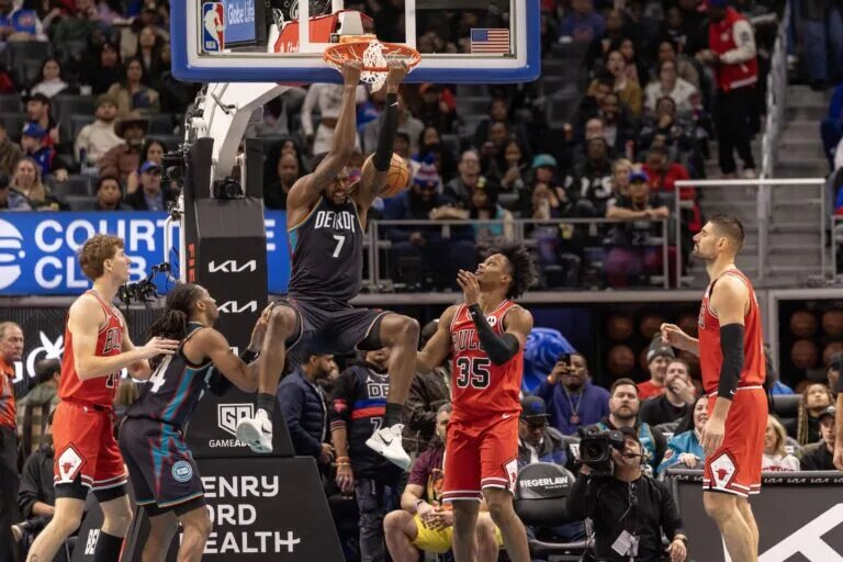 Nov 12, 2025; Detroit, Michigan, USA; Detroit Pistons forward Paul Reed (7) dunks the ball next to Chicago Bulls forward Isaac Okoro (35) during the second half at Little Caesars Arena. Mandatory Credit: David Reginek-Imagn Images