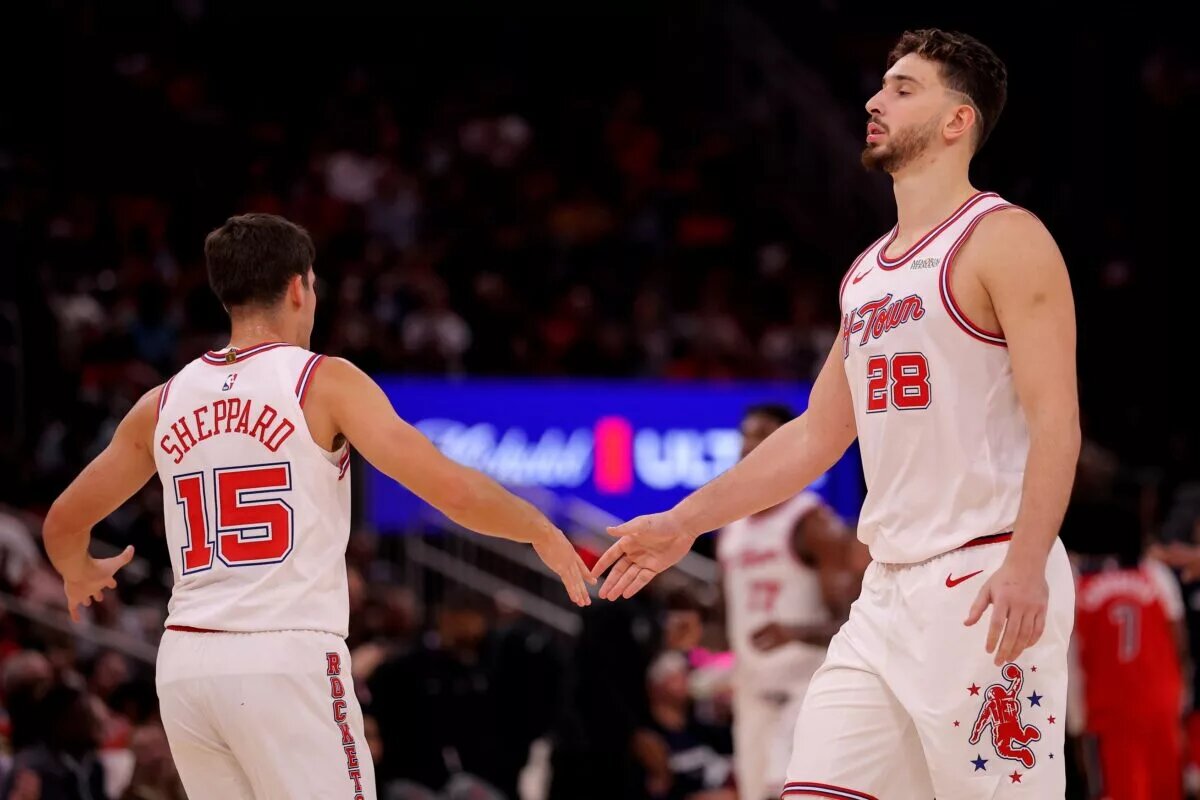 Houston Rockets guard Reed Sheppard (15) congratulates Houston Rockets center Alperen Sengun (28) during a timeout against the Washington Wizards during the fourth quarter at Toyota Center.