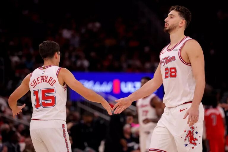 Houston Rockets guard Reed Sheppard (15) congratulates Houston Rockets center Alperen Sengun (28) during a timeout against the Washington Wizards during the fourth quarter at Toyota Center.