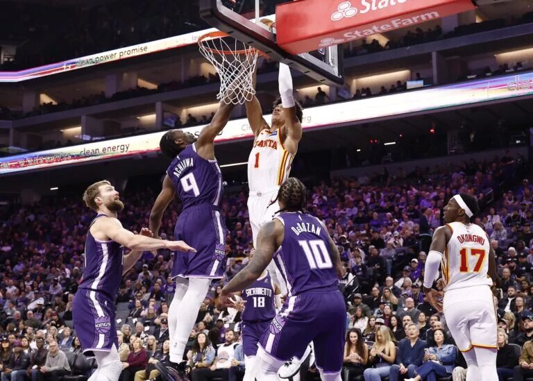 Nov 12, 2025; Sacramento, California, USA; Atlanta Hawks forward Jalen Johnson (1) dunks the ball against Sacramento Kings forward Precious Achiuwa (9) during the second quarter at Golden 1 Center. Mandatory Credit: Kelley L Cox-Imagn Images