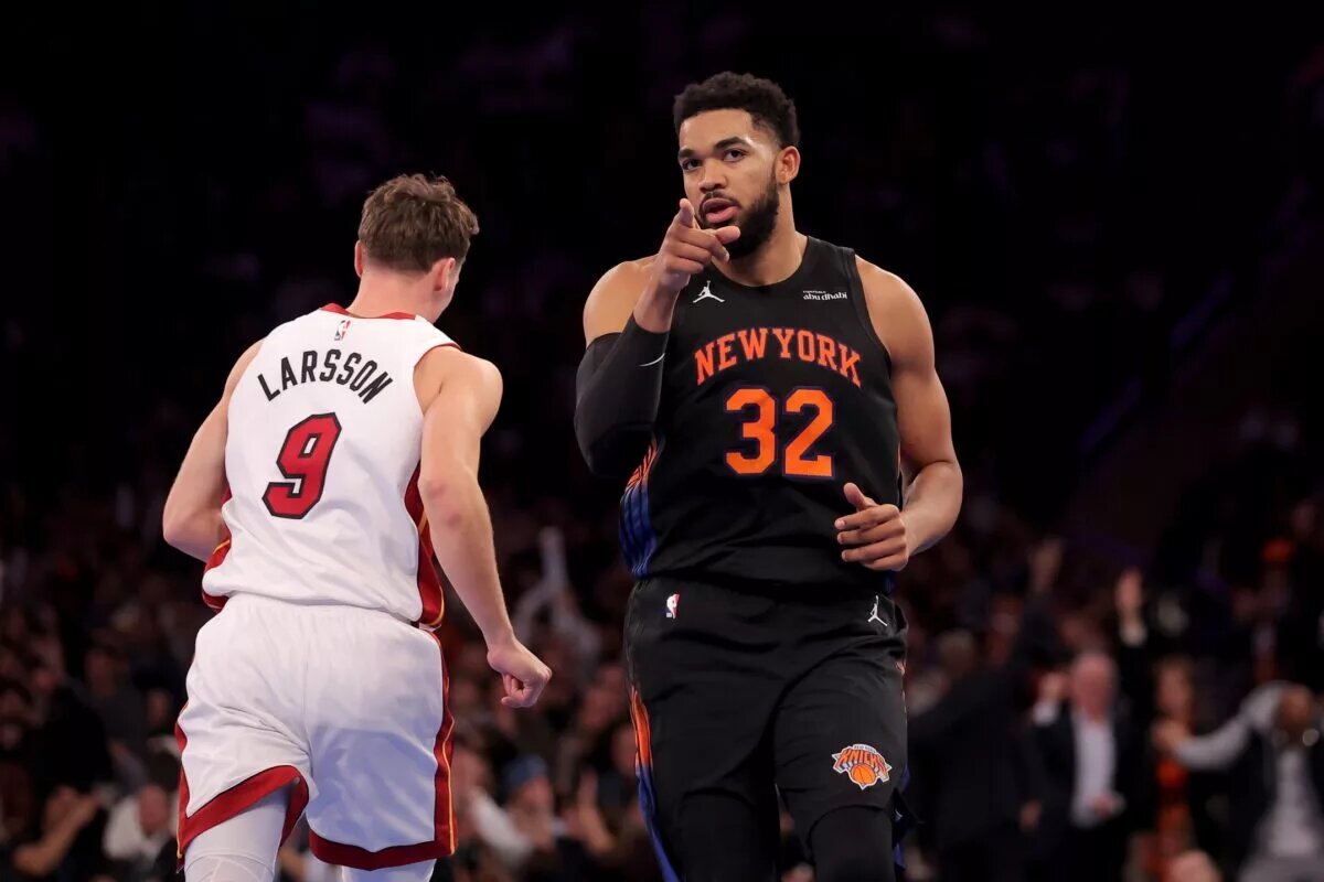 Nov 14, 2025; New York, New York, USA; New York Knicks center Karl-Anthony Towns (32) reacts after a three point shot against Miami Heat guard Pelle Larsson (9) during the second quarter at Madison Square Garden. Mandatory Credit: Brad Penner-Imagn Images