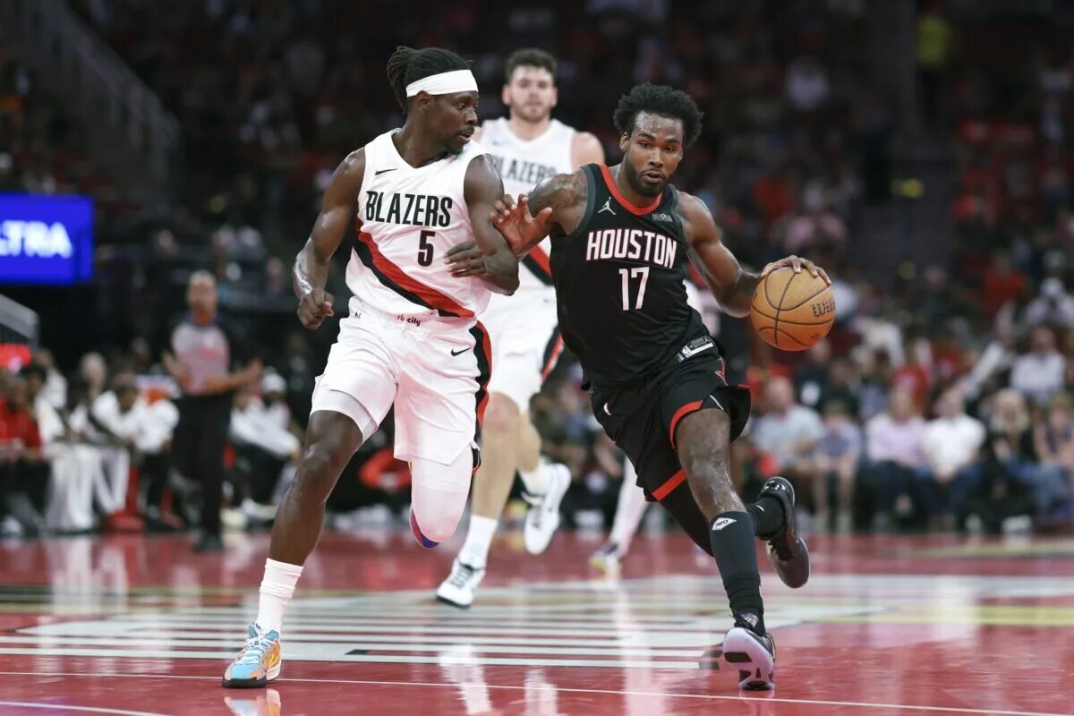 Nov 14, 2025; Houston, Texas, USA; Houston Rockets forward Tari Eason (17) drives with the ball as Portland Trail Blazers guard Jrue Holiday (5) defends during the second quarter at Toyota Center. Mandatory Credit: Troy Taormina-Imagn Images