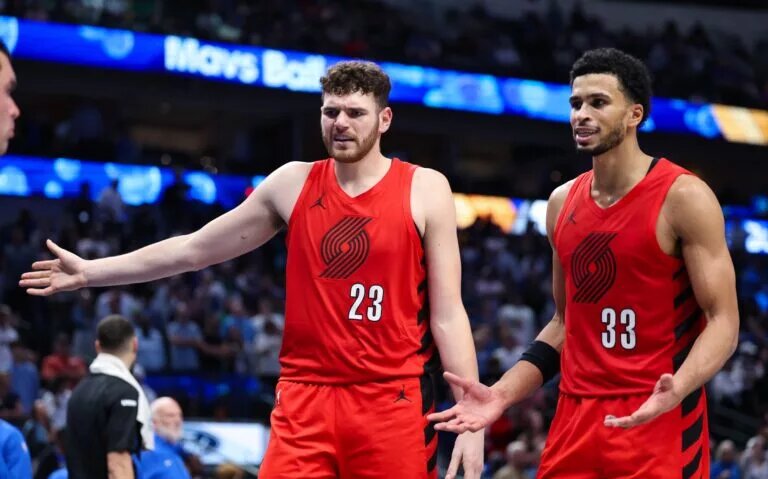 Nov 16, 2025; Dallas, Texas, USA; Portland Trail Blazers center Donovan Clingan (23) and Portland Trail Blazers forward Toumani Camara (33) react against the Dallas Mavericks in overtime at American Airlines Center. Mandatory Credit: Kevin Jairaj-Imagn Images