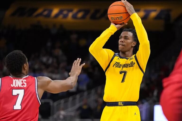 Nov 19, 2025; Milwaukee, Wisconsin, USA; Marquette Golden Eagles guard Zaide Lowery (7) shoots over Dayton Flyers forward Keonte Jones (7) during the second half at Fiserv Forum. Mandatory Credit: Jeff Hanisch-Imagn Images