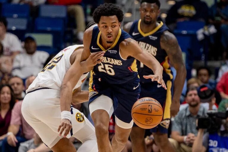 Nov 19, 2025; New Orleans, Louisiana, USA; New Orleans Pelicans forward Trey Murphy III (25) brings the ball up court against Denver Nuggets forward/center Zeke Nnaji (22) during the second half at Smoothie King Center. Mandatory Credit: Stephen Lew-Imagn Images