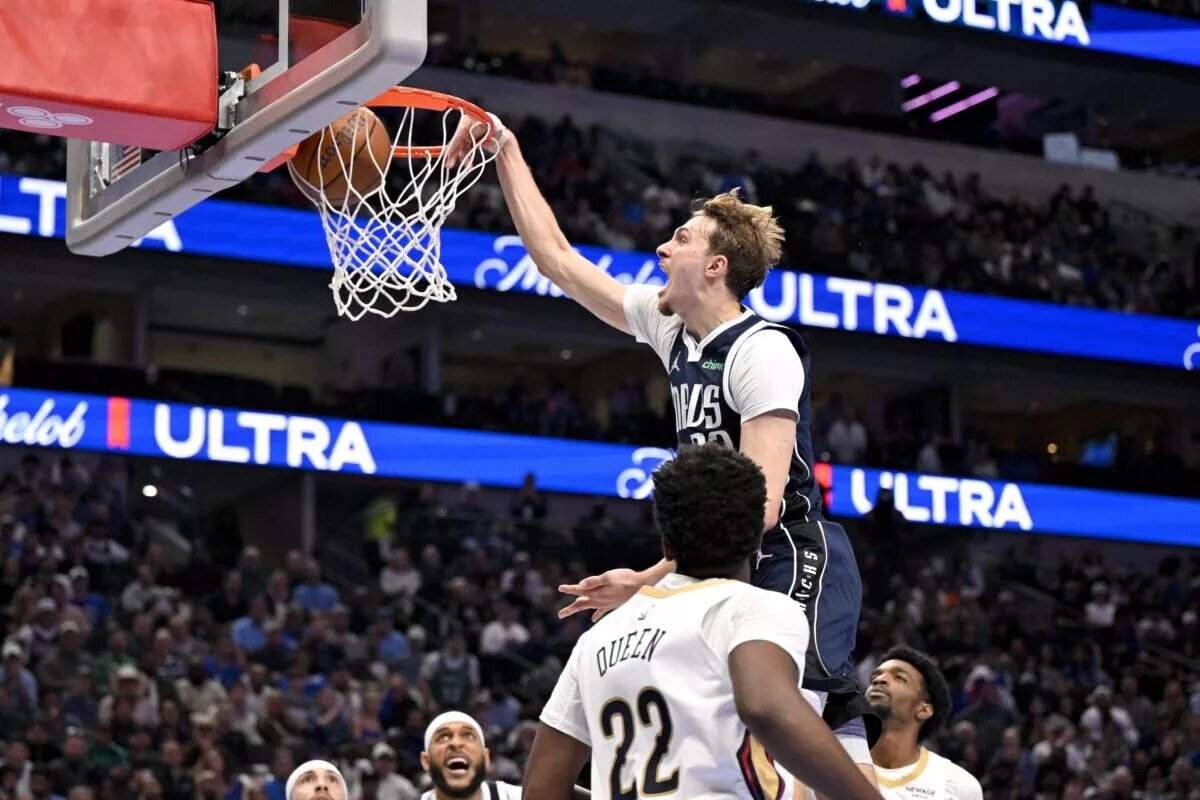 Nov 21, 2025; Dallas, Texas, USA; Dallas Mavericks forward Cooper Flagg (32) dunks the ball over New Orleans Pelicans center Derik Queen (22) and forward Herbert Jones (2) during the second half at the American Airlines Center. Mandatory Credit: Jerome Miron-Imagn Images