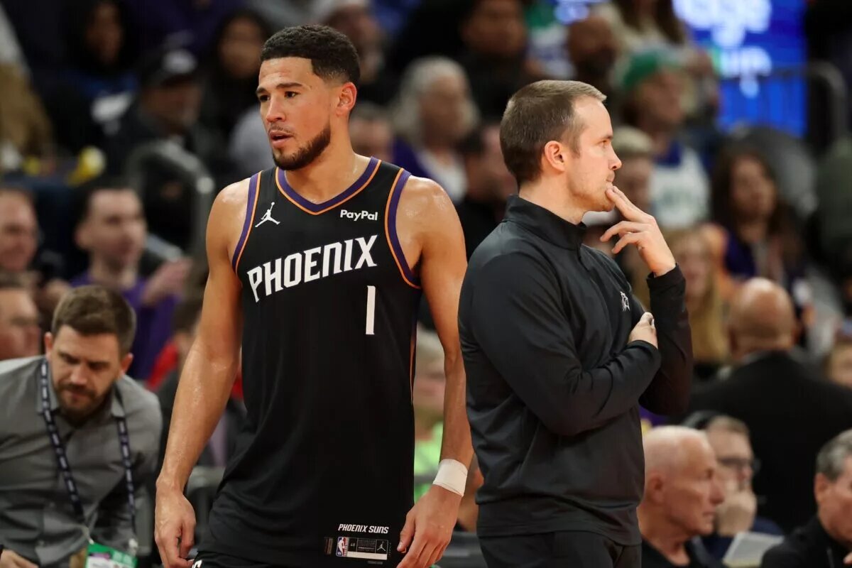 Nov 21, 2025; Phoenix, Arizona, USA; Phoenix Suns head coach Jordan Ott (left) with guard Devin Booker (1) against the Minnesota Timberwolves in the second half of an NBA Cup game at Mortgage Matchup Center. Mandatory Credit: Mark J. Rebilas-Imagn Images