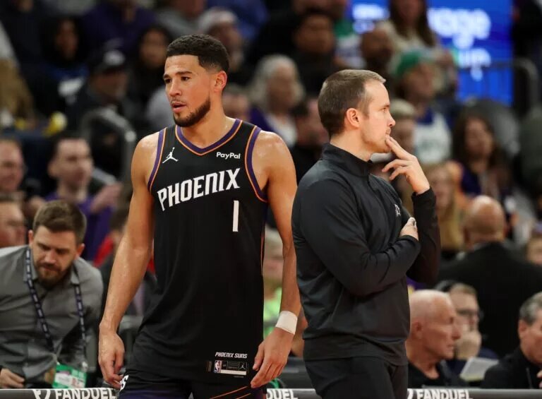 Nov 21, 2025; Phoenix, Arizona, USA; Phoenix Suns head coach Jordan Ott (left) with guard Devin Booker (1) against the Minnesota Timberwolves in the second half of an NBA Cup game at Mortgage Matchup Center. Mandatory Credit: Mark J. Rebilas-Imagn Images