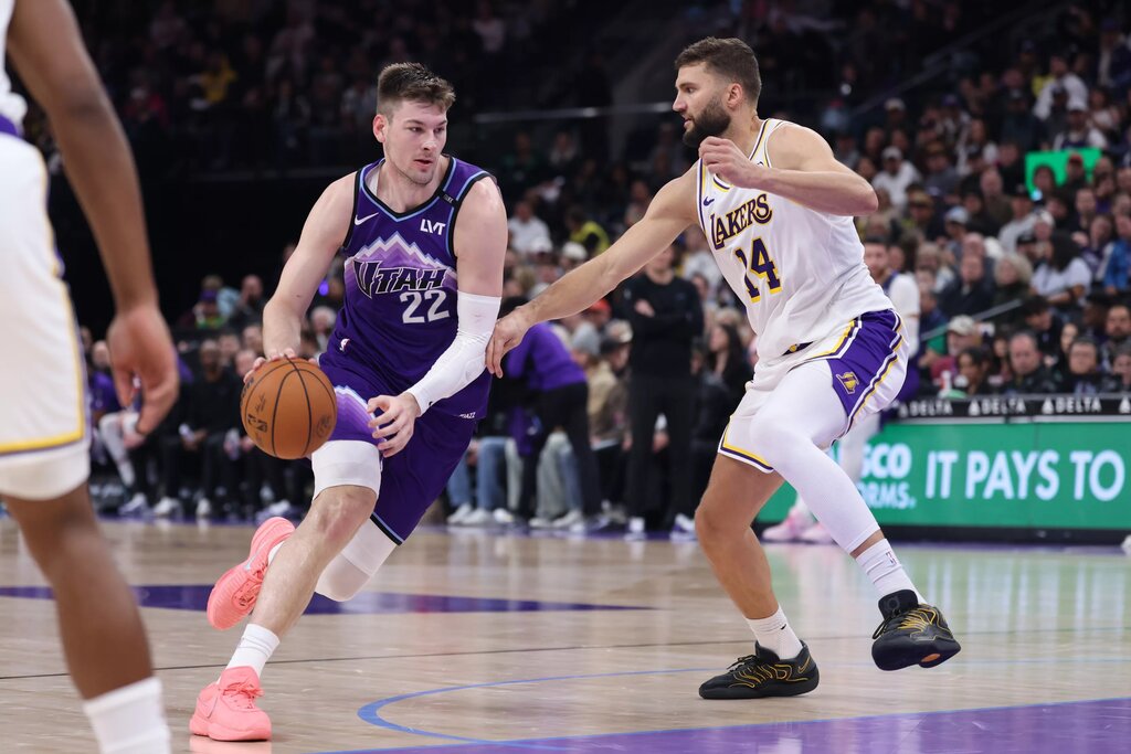 Nov 23, 2025; Salt Lake City, Utah, USA; Utah Jazz forward Kyle Filipowski (22) drives against Los Angeles Lakers forward Maxi Kleber (14) during the second half at Delta Center. Mandatory Credit: Rob Gray-Imagn Images